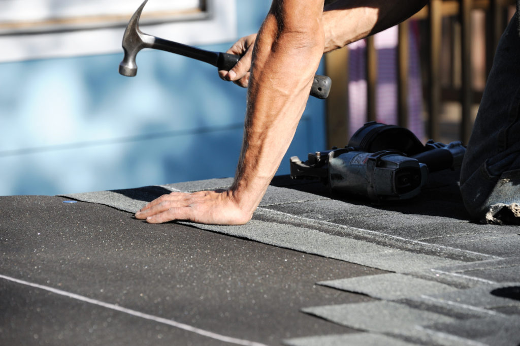 A roofer working on residential roofing replacements in Roseville, CA