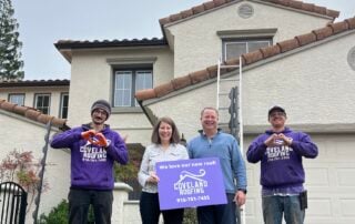 Loveland Roofing team and homeowners in front of a completed roofing project