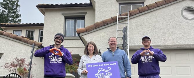 Loveland Roofing team and homeowners in front of a completed roofing project